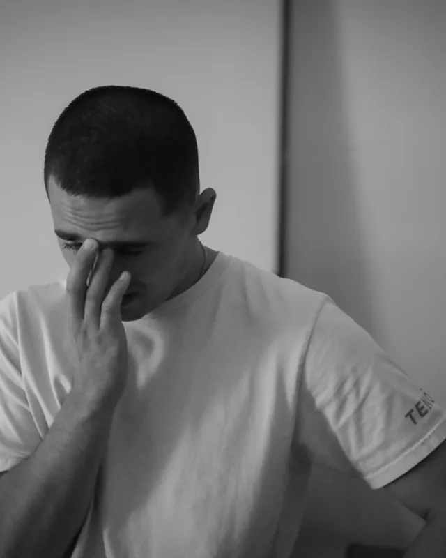 A father overcome with emotion at the birth, black and white birth photography by Jenn Miller, Orange County