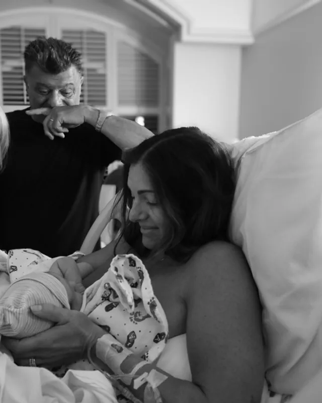 Grandparents meet their new grandchild, black and white birth photography by Jenn Miller, Orange County