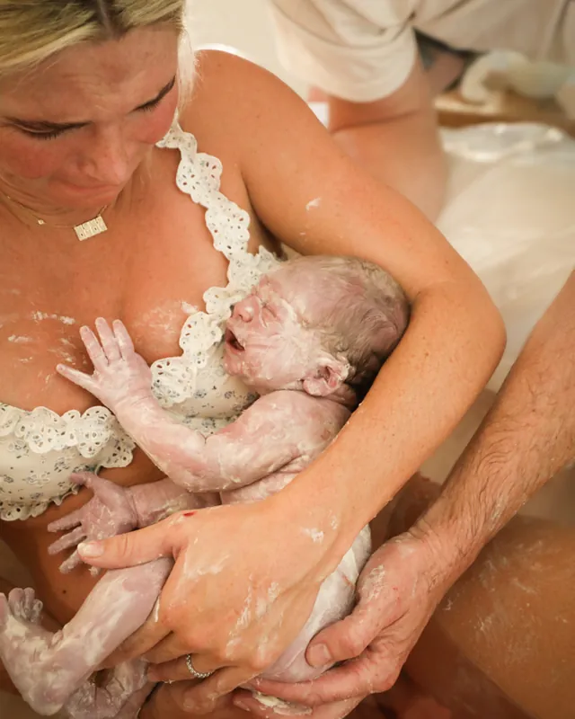 A newborn's first moments in mom's arms after a water birth, Orange County birth photography by Jenn Miller