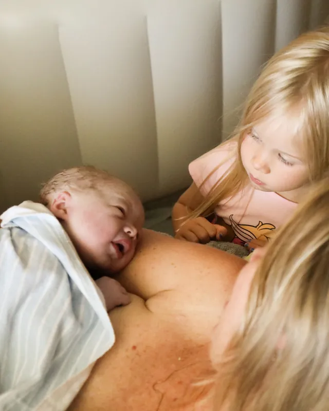 A big sister meets her newborn sibling, Orange County birth photography by Jenn Miller