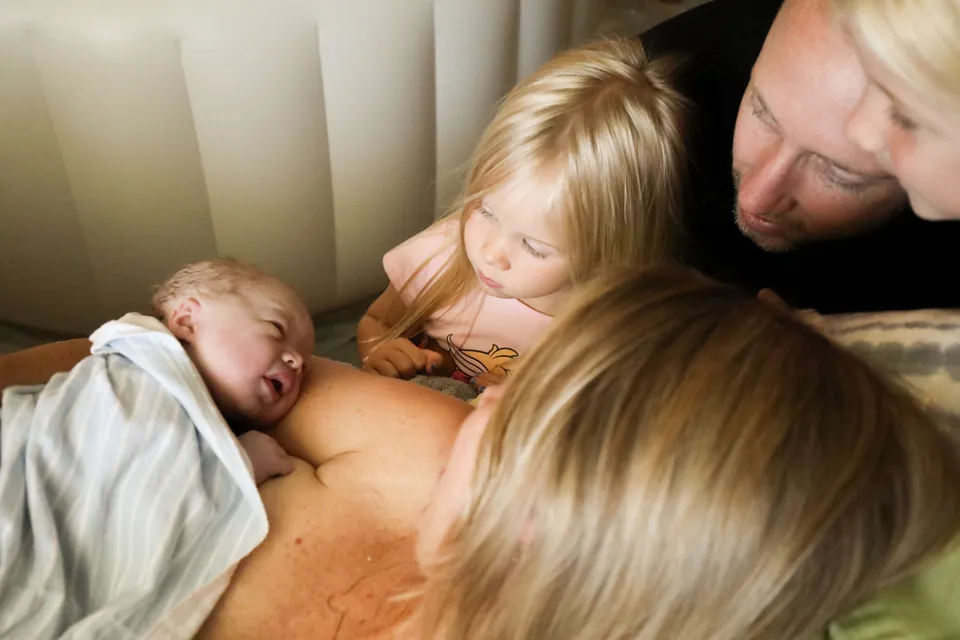 A big sister meets her newborn sibling