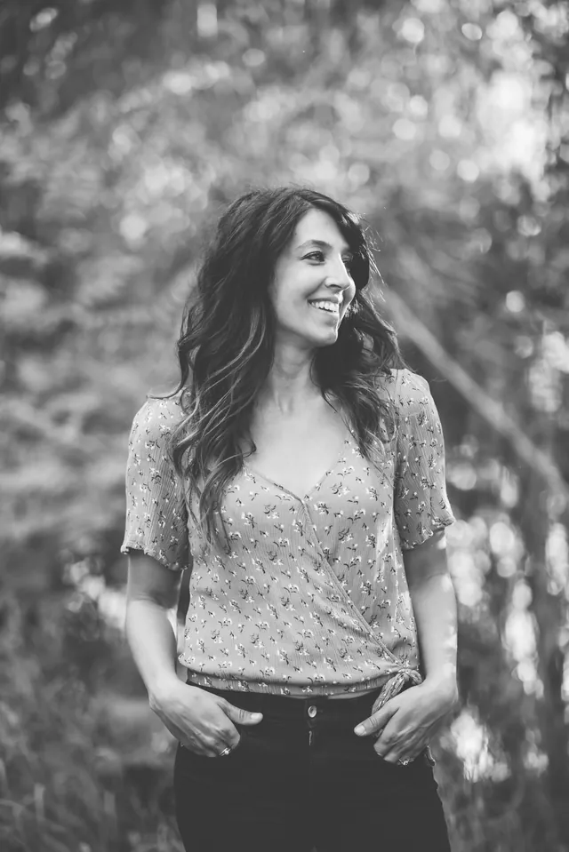 Jenn Miller, Orange County birth doula, smiling outdoors, in black and white
