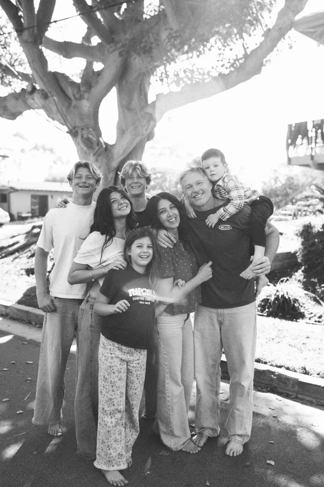 Jenn Miller and her family gathered under a tree, in black and white