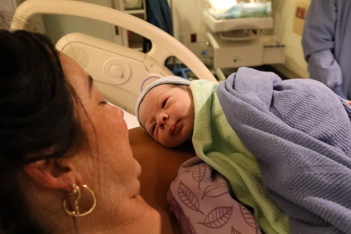 A mother's joy meeting her newborn, photographed by Jenn Miller